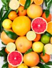 Citrusfruitsbackground.Assortedfreshcitrusfruitswithleaves.Orangegrapefruitlemonlimetangerine_edited
