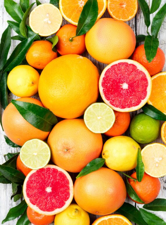 Citrusfruitsbackground.Assortedfreshcitrusfruitswithleaves.Orangegrapefruitlemonlimetangerine_edited